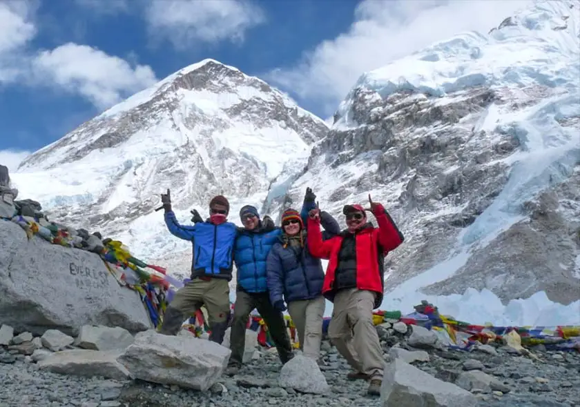 Trekkers posing in front of Mount Everest